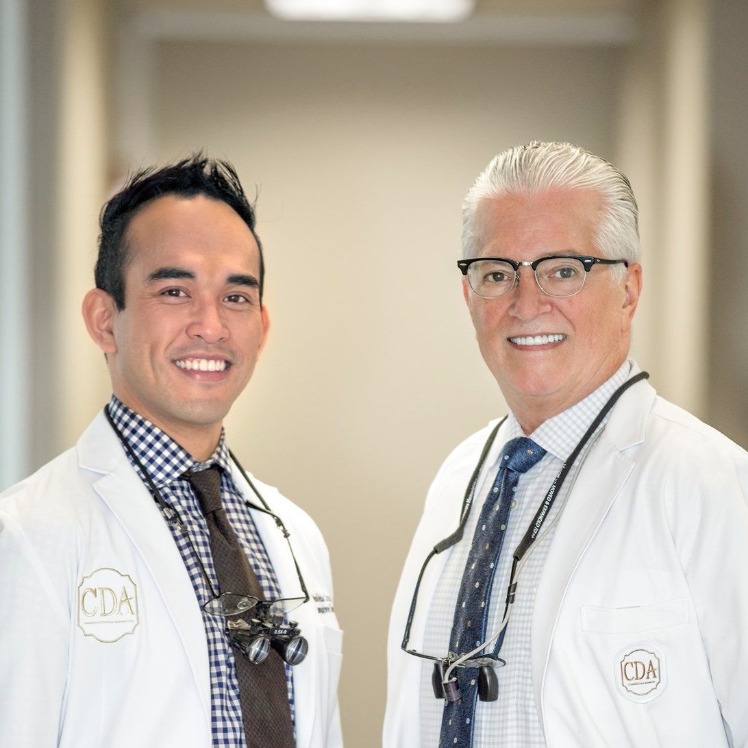 Dr. Landry + Dr. Cruz smiling in the office