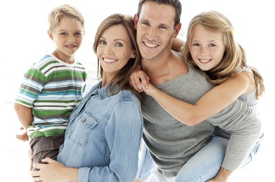 a family of 4 smiling together