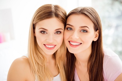 2 woman smiling together