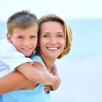 a mother and son smiling