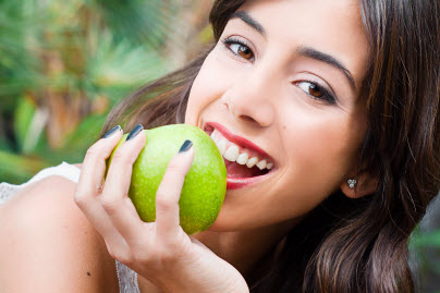 a woman eating an apple