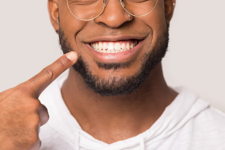 man pointing at his beautiful smile