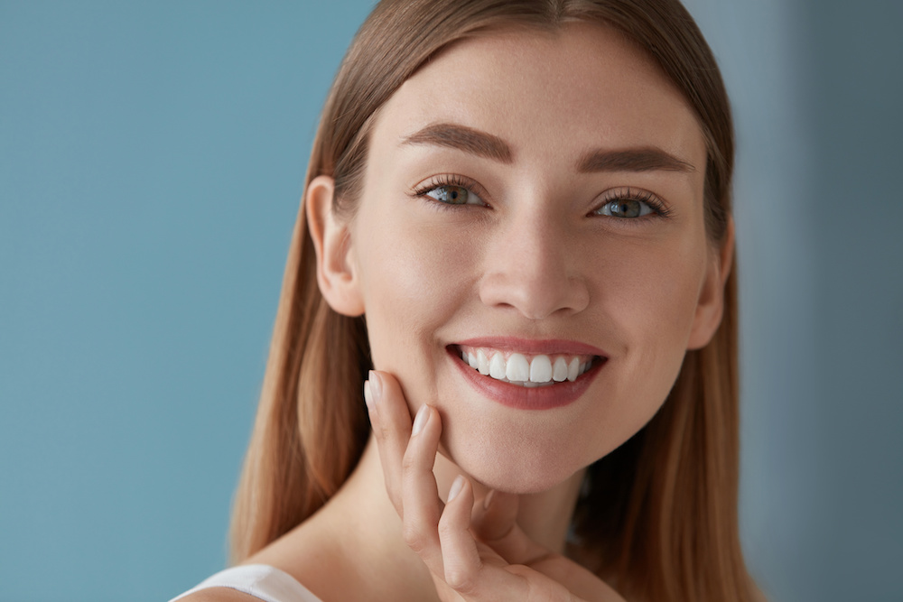 Beauty portrait of smiling woman with white teeth smile Spring Cosmetic Dentist